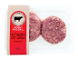 Dois hambúrgueres de carne bovina crua com cebola em embalagem transparente, com o rótulo 'BOVINO NACIONAL'.