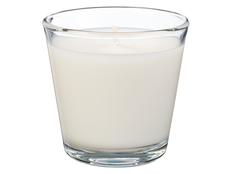 Vela branca num copo de vidro.