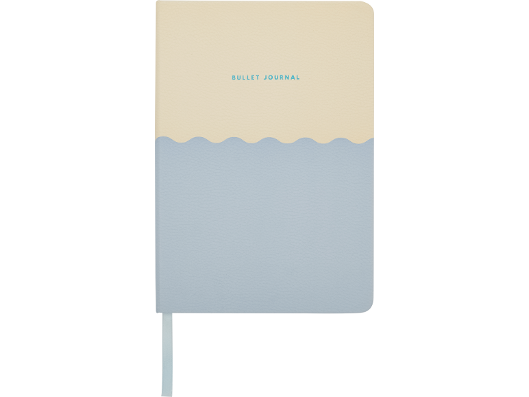Bullet journal com parte superior creme e parte inferior azul claro, separadas por uma linha ondulada.