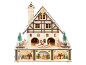 Casa de Natal de madeira com iluminação, figuras de Pai Natal e renas, e árvores de Natal.