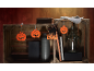Decorações de Halloween com recortes de abóbora e um recorte de gato preto com o texto 'BOO'.