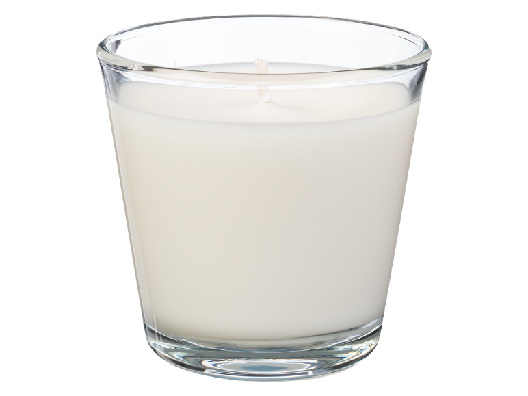 Vela branca num copo de vidro.