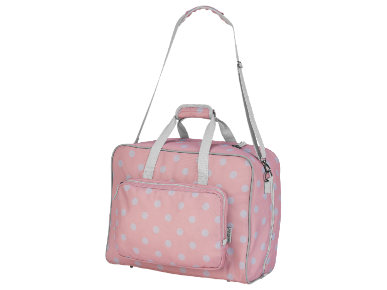 Mala de viagem rosa com bolinhas brancas e alça de ombro.