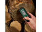 Medidor de humidade digital com ecrã a mostrar 0.0% e 22.9°C, segurado em lenha.