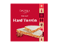 Turrón redondo duro com amêndoas sobre fundo vermelho com motivos natalícios.