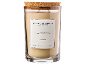 Vela perfumada em frasco de vidro com tampa de cortiça, rotulada 'Sublime Patchouli'.