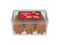 Biscoitos estrela de avelã numa caixa transparente, com um rótulo vermelho com tema de Natal.