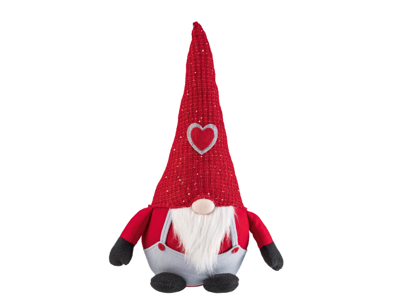 Gnomo de pelúcia com chapéu vermelho, barba e coração, perfeito para decoração festiva.