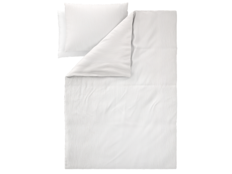Conjunto de cama branco enrugado com almofada e edredão.