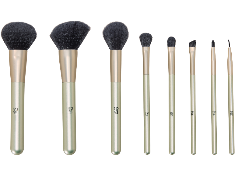 Conjunto de oito pincéis de maquilhagem com cerdas pretas e cabos verde claro.