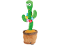 Brinquedo de cacto de pelúcia verde com olhos esbugalhados, um sorriso vermelho e decorações de flores coloridas num vaso.
