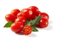 Tomates cereja vermelhos frescos com folhas verdes e gotas de água.