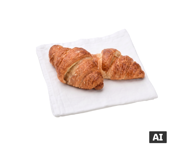 Dois croissants dourados sobre um guardanapo branco [imagem gerada por IA]