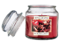 Vela perfumada de maçã e canela com tampa de vidro separada.