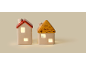 Duas decorações de casas de cerâmica iluminadas com telhados vermelhos e amarelos.
