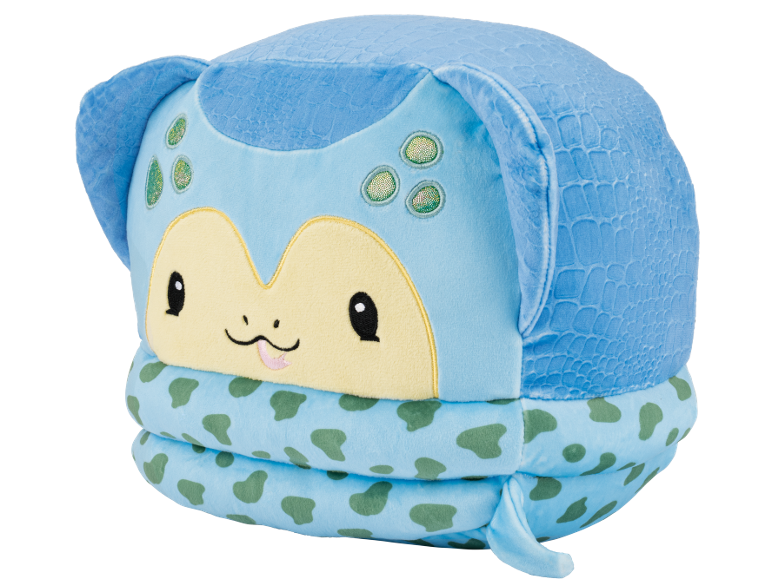 Peluche azul com rosto amarelo, olhos pretos e manchas verdes, com textura de escamas.