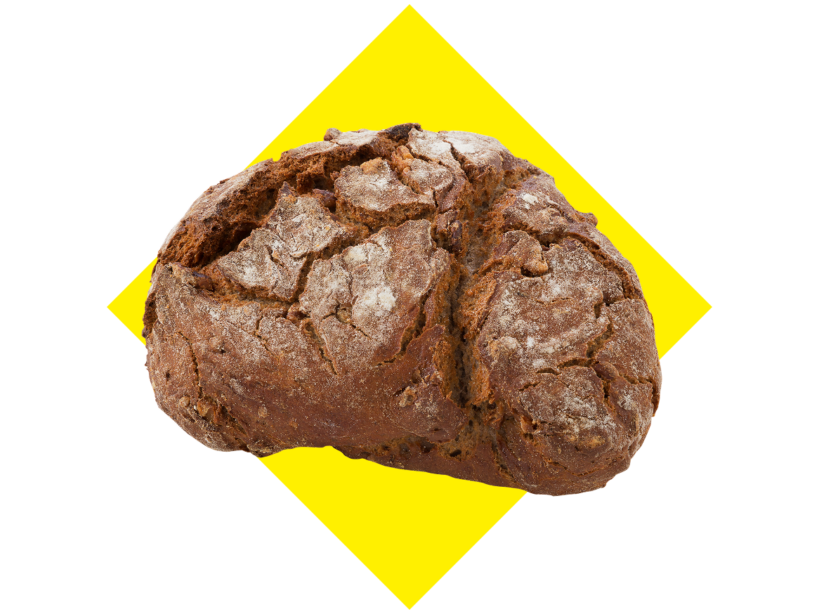 Pão rústico de forma redonda com crosta estaladiça, sobre fundo preto e amarelo.